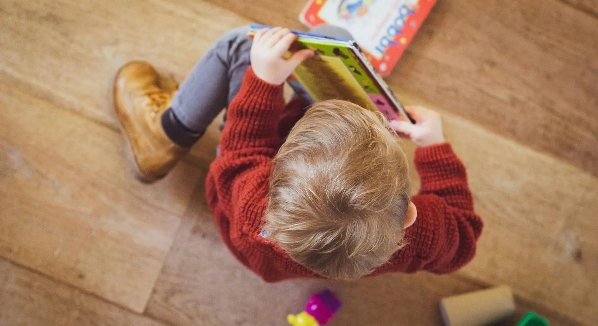 learn-more-about-our-testing A young boy opening a book.