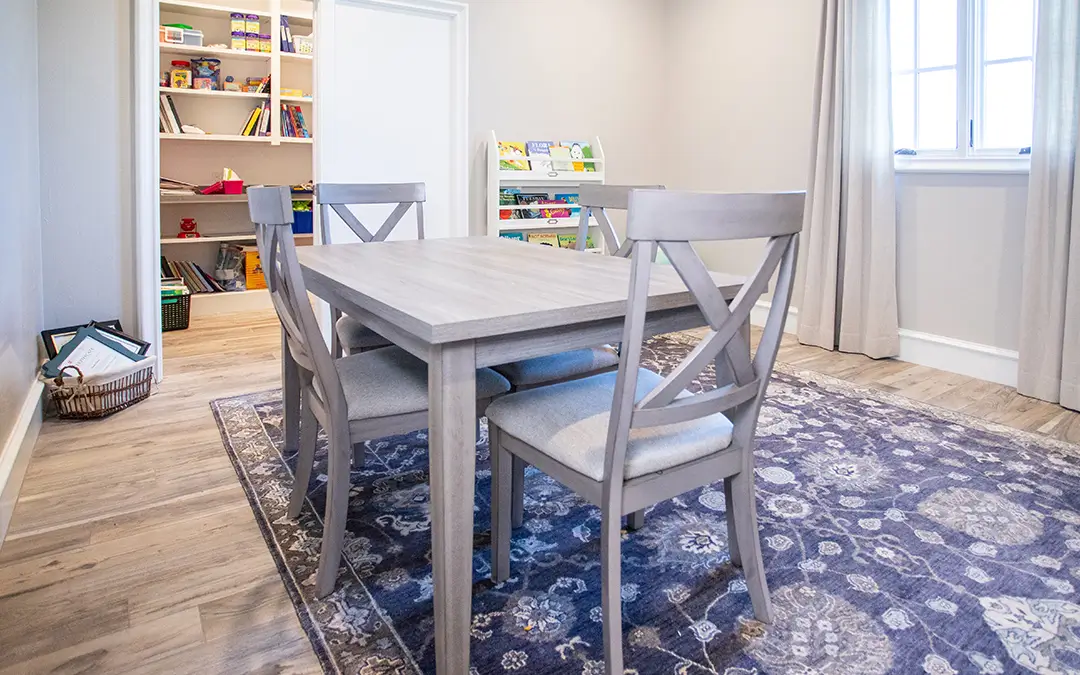 Private assessment room with child-sized table, chairs, bookshelves, and learning materials used for Educational assessments Edmond and language development evaluations.