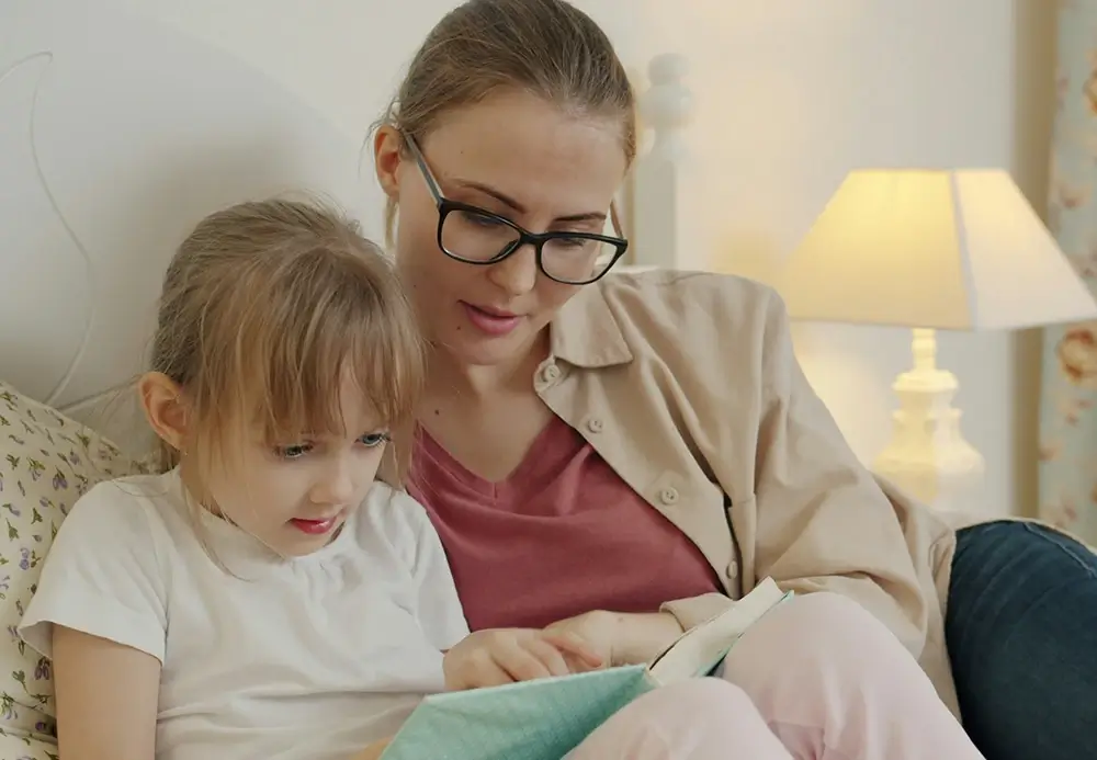 A mother reading with her daughter