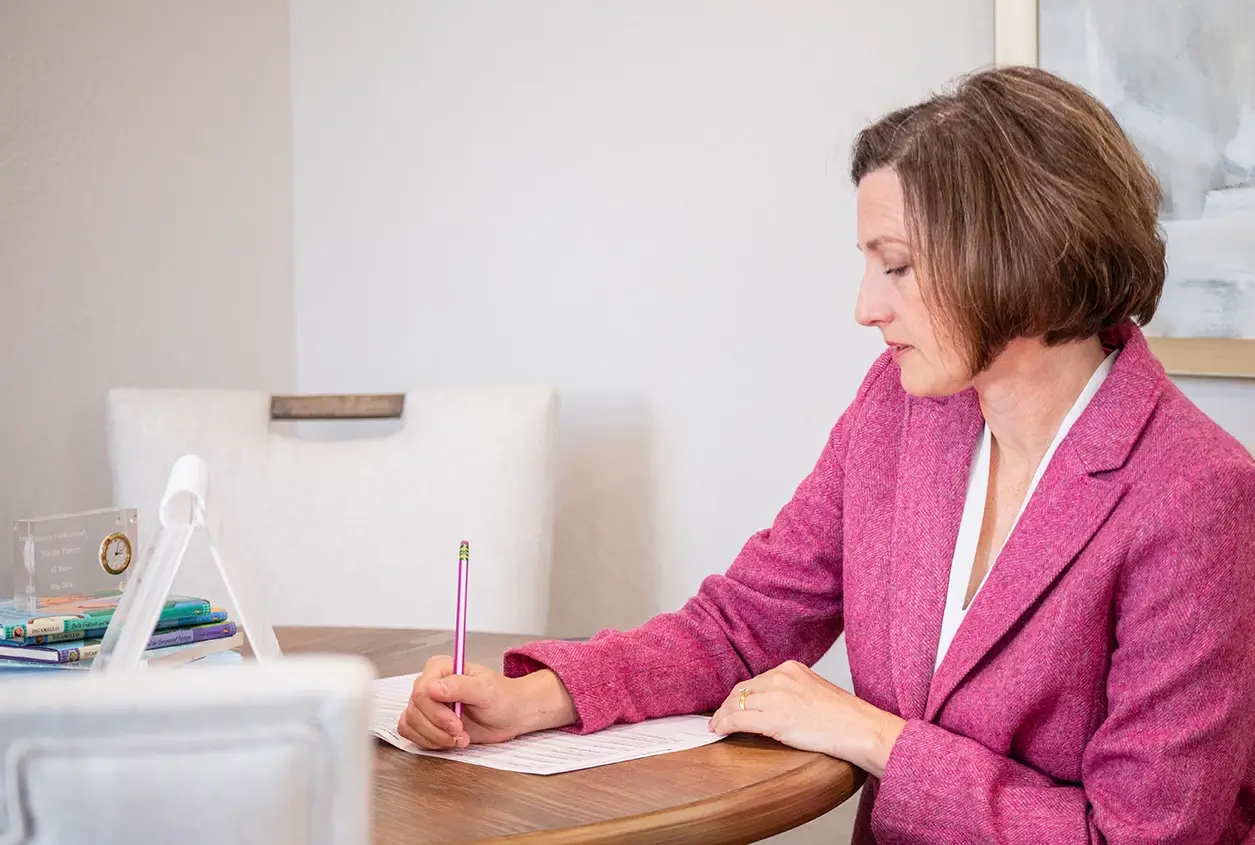 SLP-Taking-Notes Nicole Power, a speech language pathologist OKC, taking notes during a speech and language evaluation